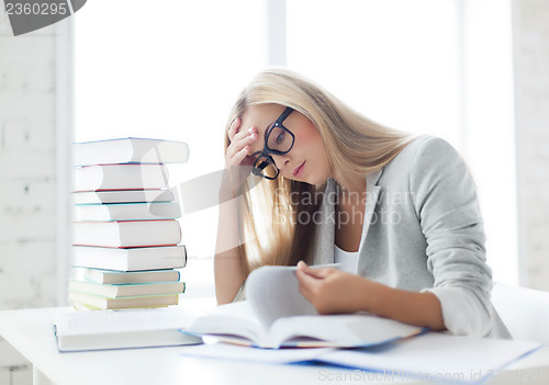 Image of student with books and notes
