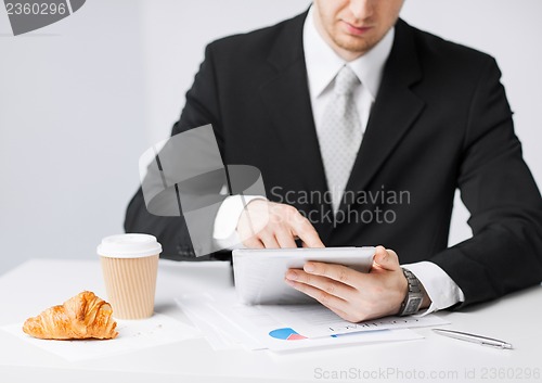 Image of man with tablet pc and cup of coffee