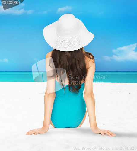 Image of model posing in swimsuit with hat