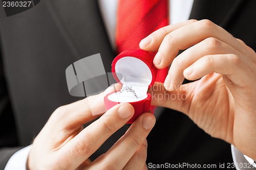 Image of man with wedding ring and gift box