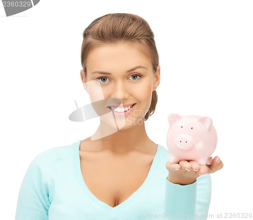 Image of lovely woman with small piggy bank