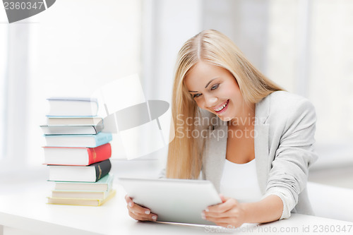 Image of student with books and tablet pc