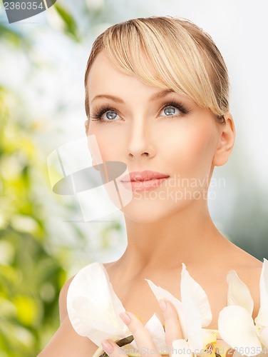 Image of woman with white orchid flower