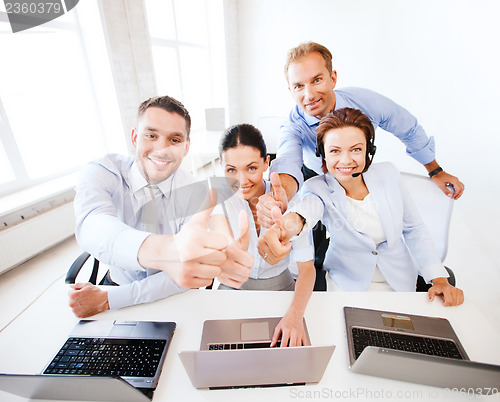 Image of group of office workers showing thumbs up