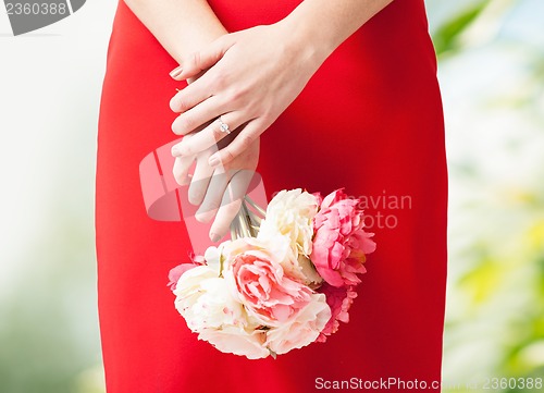 Image of woman hands with flowers and ring