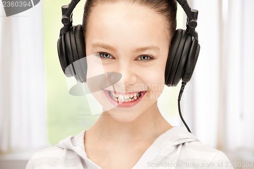 Image of happy teenage girl in big headphones