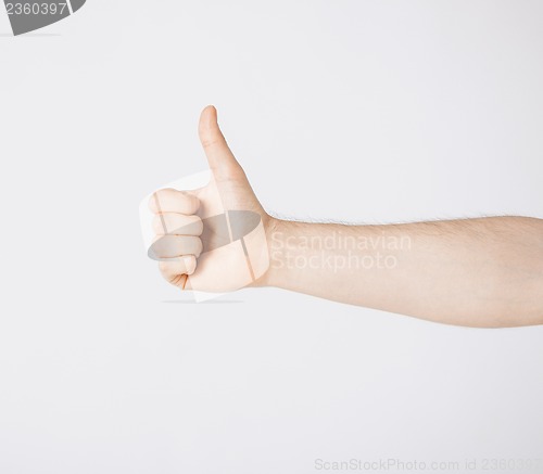 Image of man showing thumbs up