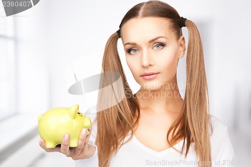 Image of lovely woman with piggy bank
