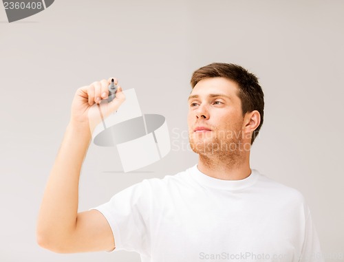 Image of man writing something in the air