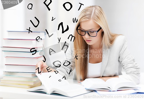 Image of student with books and notes