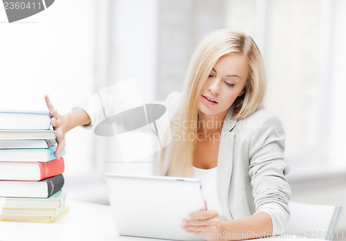 Image of student with books and tablet pc