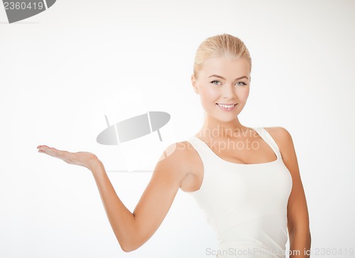 Image of woman in sportswear with empty hand