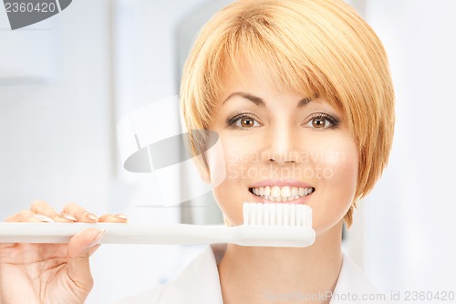 Image of doctor with toothbrush