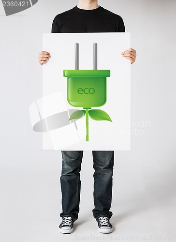 Image of hands holding picture of green electrica ecol plug