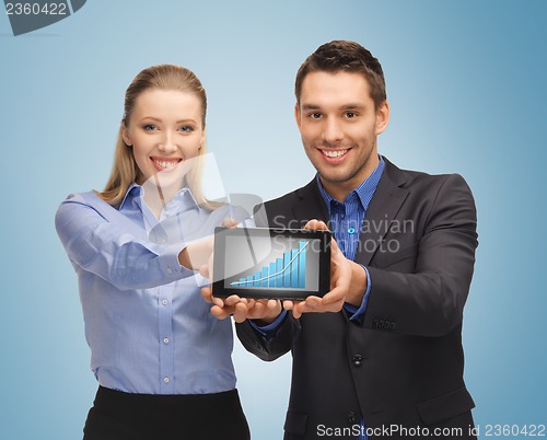 Image of two business people showing tablet pc with graph