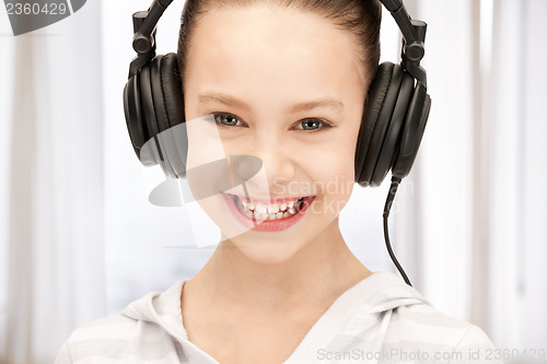 Image of happy teenage girl in big headphones