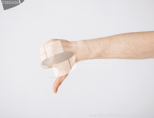 Image of man showing thumbs down