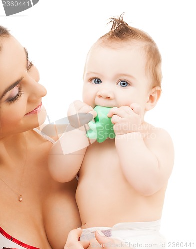 Image of curious baby biting toy