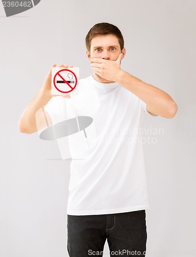 Image of young man holding no smoking sign