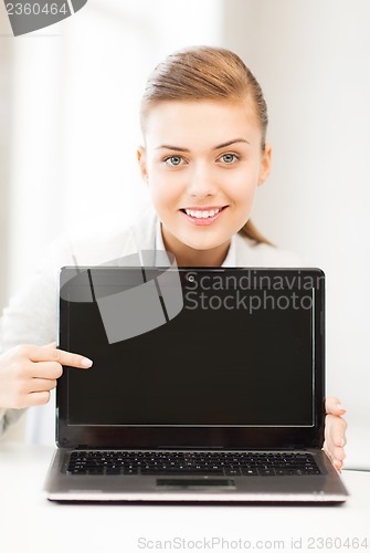 Image of businesswoman with laptop in office