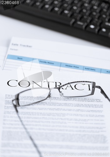 Image of signed contract paper with glasses