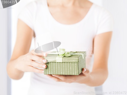 Image of woman hands with gift box