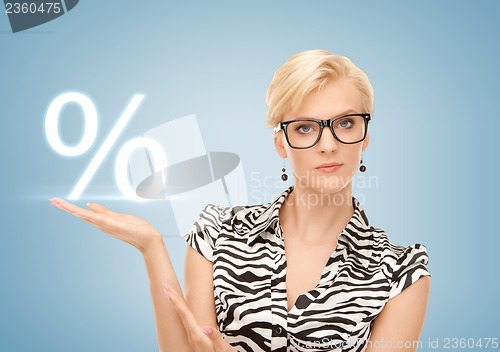 Image of woman showing sign of percent in her hand