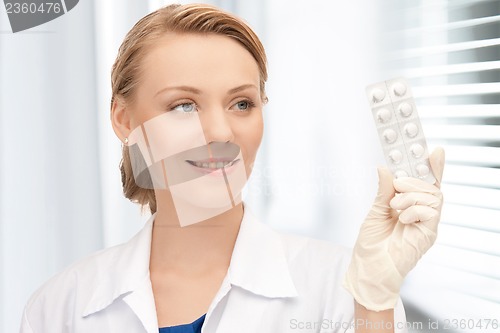 Image of attractive female doctor with pills