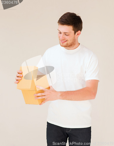 Image of man in white t-shirt with gift box