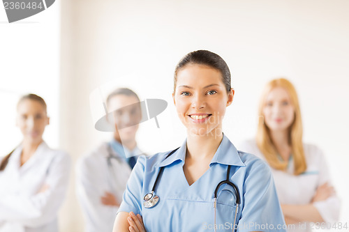 Image of female doctor in front of medical group