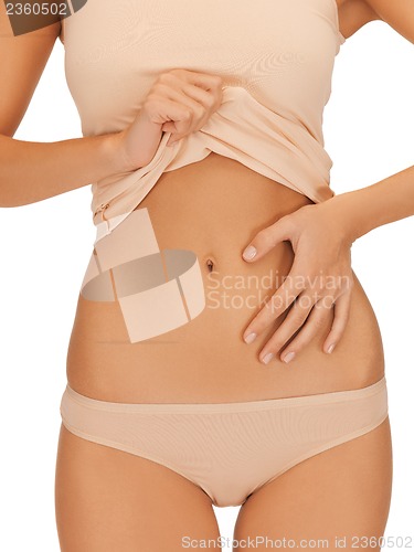 Image of woman placing hand on her belly