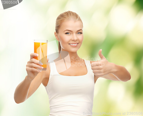 Image of woman holding glass of orange juice