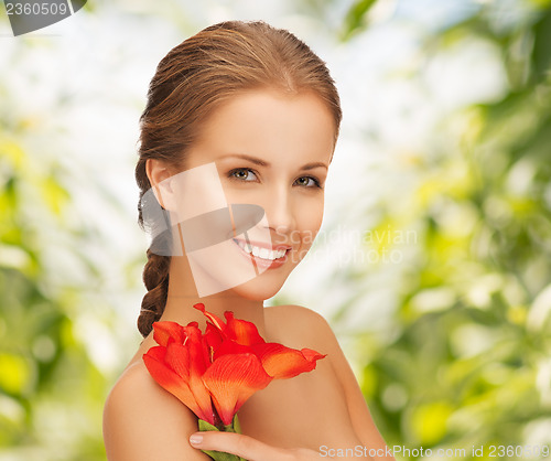 Image of beautiful woman with red lily flower