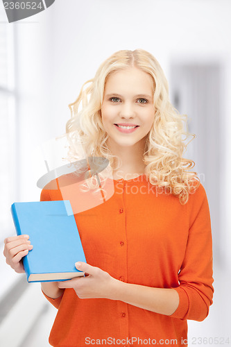 Image of happy and smiling woman with book