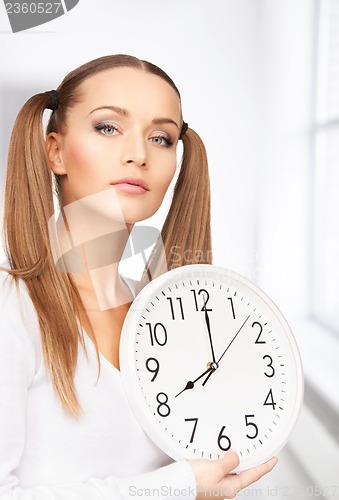 Image of woman holding big clock