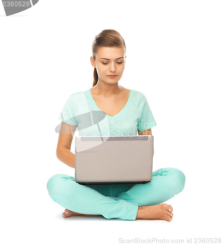 Image of young girl sitting on the floor with laptop