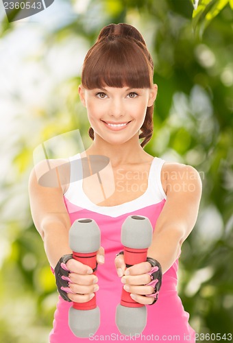 Image of fitness instructor with dumbbells