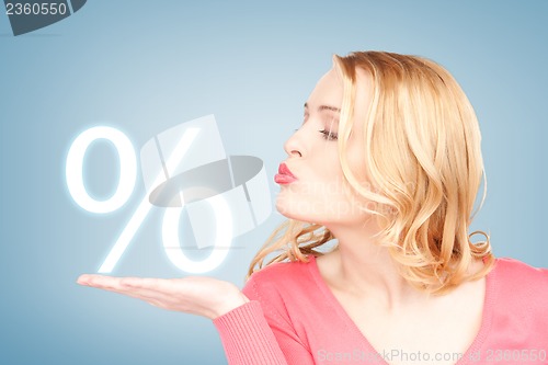 Image of woman showing sign of percent in her hand