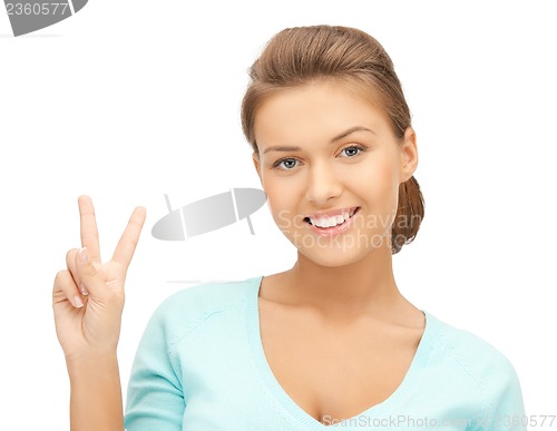 Image of young woman showing victory or peace sign