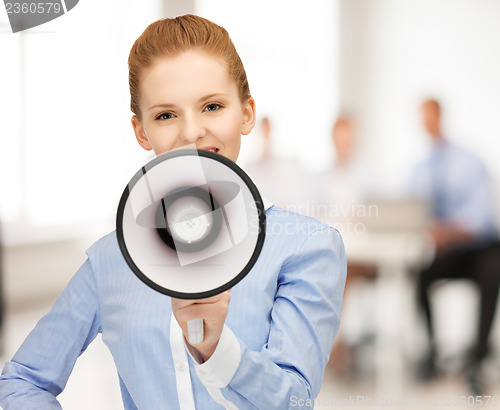 Image of businesswoman with megaphone in office