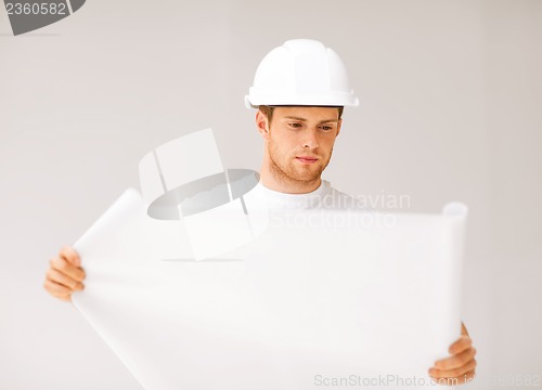 Image of male architect looking at blueprint