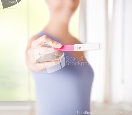 Image of woman with pregnancy test