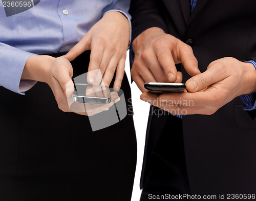 Image of woman and man hands with smartphones