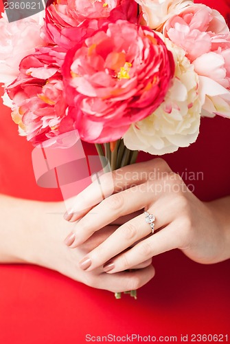 Image of woman hands with flowers and ring