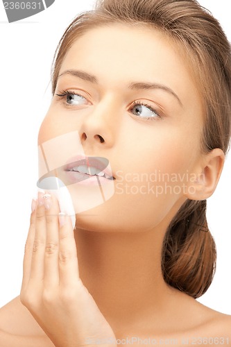 Image of beautiful woman with cotton pad