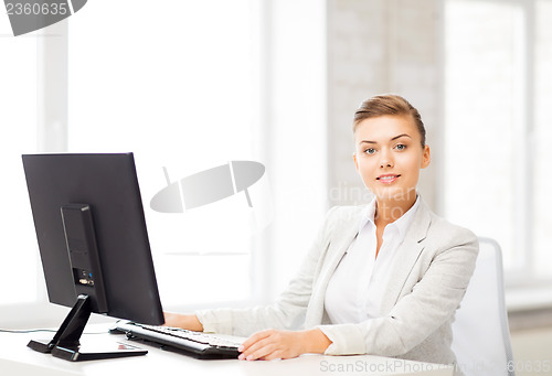 Image of businesswoman with computer in office