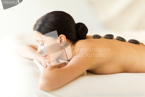 Image of woman in spa with hot stones