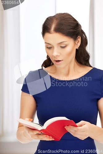 Image of surprised woman with book