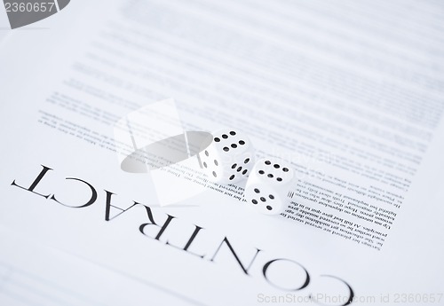 Image of contract paper with gambling dices