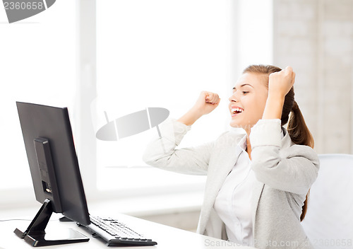 Image of businesswoman with computer in office